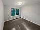 Bedroom with a window view showing trees and gray walls with neutral color carpet at 3279 Wild Basil Ln, Buford, GA 30519