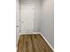 Hallway features wood-look flooring and a white painted door at 3279 Wild Basil Ln, Buford, GA 30519