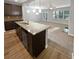 Kitchen island with granite countertops offers ample prep space and adjoins the Gathering room at 3279 Wild Basil Ln, Buford, GA 30519