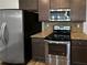 Stainless steel appliances and granite countertops highlight this cozy kitchen space at 3279 Wild Basil Ln, Buford, GA 30519
