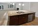 Kitchen island with granite countertop, stainless sink, and ample cabinetry at 3279 Wild Basil Ln, Buford, GA 30519
