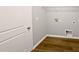 Laundry room showcasing wood-look flooring and utility connections at 3279 Wild Basil Ln, Buford, GA 30519