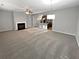 Open-concept living room with a fireplace that overlooks the modern kitchen at 3279 Wild Basil Ln, Buford, GA 30519
