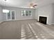 Bright living room with fireplace, ceiling fan, and french doors leading to backyard at 3279 Wild Basil Ln, Buford, GA 30519