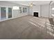 Bright living room featuring large windows, a fireplace, and carpeted floors at 3279 Wild Basil Ln, Buford, GA 30519