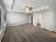 Spacious main bedroom with tray ceiling, carpet flooring, and ensuite bathroom at 3279 Wild Basil Ln, Buford, GA 30519