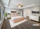 Spacious main bedroom with tray ceiling, carpet flooring, and ensuite bathroom at 3279 Wild Basil Ln, Buford, GA 30519