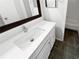 Bright bathroom with white vanity, modern faucet, large mirror, and a view into the tiled shower and tub area at 504 Vicksburg Pl, Atlanta, GA 30350