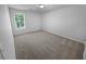 Simple bedroom with soft carpet, neutral paint, and bright natural light at 504 Vicksburg Pl, Atlanta, GA 30350