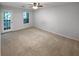 Serene bedroom with carpet, featuring a ceiling fan and access to a private balcony at 504 Vicksburg Pl, Atlanta, GA 30350