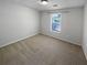 Comfortable bedroom featuring plush carpet and a window providing natural light at 504 Vicksburg Pl, Atlanta, GA 30350