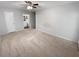 Bright bedroom featuring soft carpet, a ceiling fan and an ensuite bathroom entrance at 504 Vicksburg Pl, Atlanta, GA 30350