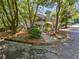 Inviting two-story condo featuring a charming balcony, lush greenery, and a tree-lined walkway at 504 Vicksburg Pl, Atlanta, GA 30350