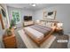 Comfortable main bedroom with a queen-sized bed, stylish decor, and a window view at 504 Vicksburg Pl, Atlanta, GA 30350
