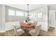 Cozy dining area features classic decor and a round wooden table with seating for four at 112 Laurel Farms Ln, Dallas, GA 30157