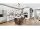 Bright kitchen features a center island, stainless steel appliances, and stone fireplace in an open floor plan at 112 Laurel Farms Ln, Dallas, GA 30157