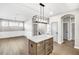 Eat-in kitchen features an island and a view into the adjacent living room at 112 Laurel Farms Ln, Dallas, GA 30157