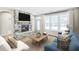 Inviting living room with a stone fireplace, a comfortable sofa, and large windows at 112 Laurel Farms Ln, Dallas, GA 30157
