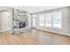 Bright, airy living room with a stone fireplace, large windows, and natural light at 112 Laurel Farms Ln, Dallas, GA 30157