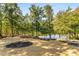 Landscaped backyard with lake access and dock at 8316 Hewlett Rd, Sandy Springs, GA 30350
