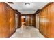 Basement hallway with wood paneling and tile floor at 8316 Hewlett Rd, Sandy Springs, GA 30350