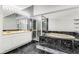 Modern bathroom with a soaking tub and marble floors at 8316 Hewlett Rd, Sandy Springs, GA 30350