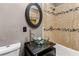 Bathroom with glass sink and beige tile shower at 8316 Hewlett Rd, Sandy Springs, GA 30350