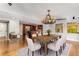 Open concept dining room with kitchen view and hardwood floors at 8316 Hewlett Rd, Sandy Springs, GA 30350