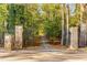 Private gated entrance leading to a wooded area at 8316 Hewlett Rd, Sandy Springs, GA 30350