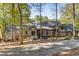 House exterior showcasing a large home with stone accents and landscaping at 8316 Hewlett Rd, Sandy Springs, GA 30350