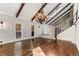 Open living room with hardwood floors, exposed beams, and a grand chandelier at 8316 Hewlett Rd, Sandy Springs, GA 30350