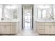 Double vanity bathroom with marble countertops and herringbone tile floor at 443 Wimbledon Ne Rd, Atlanta, GA 30324