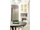 Butlers pantry with wine cooler and dark tile backsplash at 443 Wimbledon Ne Rd, Atlanta, GA 30324