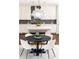 Round dining table with white chairs in a bright area at 443 Wimbledon Ne Rd, Atlanta, GA 30324