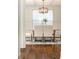 Bright dining room features a rustic wooden table with upholstered chairs and a modern chandelier at 443 Wimbledon Ne Rd, Atlanta, GA 30324