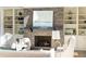 Living room fireplace with built-in shelving and a large art piece above at 443 Wimbledon Ne Rd, Atlanta, GA 30324