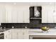 Modern kitchen with white cabinets and dark tile backsplash at 443 Wimbledon Ne Rd, Atlanta, GA 30324