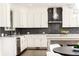 Modern kitchen with white cabinets, island, and stainless steel appliances at 443 Wimbledon Ne Rd, Atlanta, GA 30324