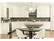 Modern kitchen with white cabinets and dark tile backsplash at 443 Wimbledon Ne Rd, Atlanta, GA 30324