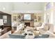 Open living room with a brick fireplace, built-in shelves, and hardwood floors at 443 Wimbledon Ne Rd, Atlanta, GA 30324