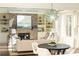 Spacious living room with a brick fireplace, built-in shelving, and large windows at 443 Wimbledon Ne Rd, Atlanta, GA 30324
