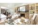 Two-story living room features a brick fireplace and built-in shelving units at 443 Wimbledon Ne Rd, Atlanta, GA 30324