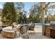 Relaxing patio with fire pit, wicker chairs, and pool views at 443 Wimbledon Ne Rd, Atlanta, GA 30324