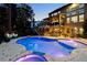 Night view of a kidney-shaped pool and spa at 443 Wimbledon Ne Rd, Atlanta, GA 30324