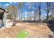 Large, fenced backyard featuring a patio, mature trees, and plenty of space for outdoor activities at 374 Cherington Ln, Lawrenceville, GA 30044