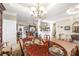 Open-concept dining room with hardwood floors and views into the cozy living area at 374 Cherington Ln, Lawrenceville, GA 30044