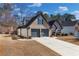 Lovely home showcasing brick facade, side yard, and a two-car garage at 374 Cherington Ln, Lawrenceville, GA 30044