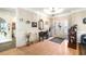 Grand foyer with paneled walls, light hardwood floors, and a decorative front door with sidelights at 374 Cherington Ln, Lawrenceville, GA 30044