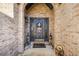 Welcoming front entrance featuring a decorative door with detailed brick surround and sconce lighting at 374 Cherington Ln, Lawrenceville, GA 30044