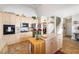 Well-lit kitchen featuring light wood cabinetry, stainless steel appliances, and a functional center island at 374 Cherington Ln, Lawrenceville, GA 30044